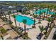 Birds-eye view of community pool with palm trees, lounge chairs, and a nearby building at 11899 N Spearfish St, Surprise, AZ 85388