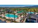 Stunning aerial view of the community pool featuring many palm trees and lounge chairs at 11899 N Spearfish St, Surprise, AZ 85388