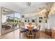 Charming dining area featuring a round wooden table, comfortable seating, and a large sliding glass door to the backyard at 11899 N Spearfish St, Surprise, AZ 85388
