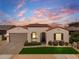 Charming single-story home featuring a terra cotta roof, manicured landscaping, and a welcoming arched entryway at 11899 N Spearfish St, Surprise, AZ 85388