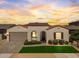 Charming single-story home featuring a terra cotta roof, manicured landscaping, and a welcoming arched entryway at 11899 N Spearfish St, Surprise, AZ 85388