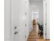 Hallway with wood floors and white doors leading to other rooms at 11899 N Spearfish St, Surprise, AZ 85388