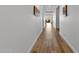 Interior hallway with hardwood floors and neutral colored walls at 11899 N Spearfish St, Surprise, AZ 85388