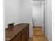Hallway with built-in cabinets, hardwood floors, and white walls at 11899 N Spearfish St, Surprise, AZ 85388