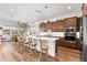 Spacious kitchen with a large island, pendant lighting, and stainless steel appliances at 11899 N Spearfish St, Surprise, AZ 85388