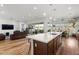 Bright, modern kitchen with a large island, sleek countertops, and an open layout to the living room and dining area at 11899 N Spearfish St, Surprise, AZ 85388