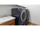 Modern laundry room featuring a high-efficiency washer and dryer set with ample counter space at 11899 N Spearfish St, Surprise, AZ 85388