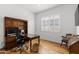 Bright office space with hardwood floors, plantation shutters, and a built-in desk and shelving unit at 11899 N Spearfish St, Surprise, AZ 85388