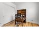 Office with hardwood floors, sliding closet doors, and a traditional wooden desk and shelving at 11899 N Spearfish St, Surprise, AZ 85388