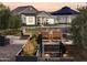 Inviting outdoor seating area with a cozy fireplace and lush landscaping, perfect for relaxing evenings at 11899 N Spearfish St, Surprise, AZ 85388