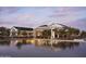 Stunning poolside view of the clubhouse, with outdoor seating and elegant architecture, reflecting in tranquil water at 11899 N Spearfish St, Surprise, AZ 85388