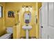 Stylish bathroom with pedestal sink, shower, and yellow walls at 12438 N Saguaro Blvd # 126, Fountain Hills, AZ 85268