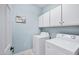 Bright laundry room with washer, dryer, and ample cabinet space at 12438 N Saguaro Blvd # 126, Fountain Hills, AZ 85268