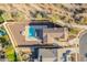 Overhead shot of a backyard featuring a pool, patio, and lush landscaping, creating a serene outdoor space at 4510 N Pierce Ct, Buckeye, AZ 85396
