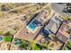 A bird's-eye view capturing a backyard with a large pool, surrounded by seating and well-maintained landscaping at 4510 N Pierce Ct, Buckeye, AZ 85396