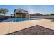 A backyard pool, patio, pergola, and gravel landscaping provide an inviting outdoor space at 4510 N Pierce Ct, Buckeye, AZ 85396