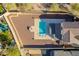 Aerial view of a luxurious backyard with a pool, complemented by modern lounge chairs at 4510 N Pierce Ct, Buckeye, AZ 85396