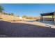 Backyard pool with pergola, gravel landscaping, and mountain views offers an inviting outdoor oasis at 4510 N Pierce Ct, Buckeye, AZ 85396