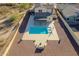 Aerial image showcasing a backyard pool with patio seating and a modern design at 4510 N Pierce Ct, Buckeye, AZ 85396