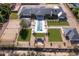 Expansive estate features a modern home, sparkling pool, lush lawns, and tennis court, creating a luxurious outdoor oasis at 6215 N Casa Blanca Dr, Paradise Valley, AZ 85253