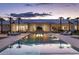 Luxury home showcases a serene backyard pool, lounge chairs, and sleek modern architecture at twilight at 6215 N Casa Blanca Dr, Paradise Valley, AZ 85253