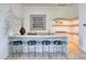 Elegant bar area with marble countertop, black leather stools, and stylish decor at 6215 N Casa Blanca Dr, Paradise Valley, AZ 85253