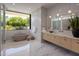 Luxurious bathroom featuring a freestanding tub, marble accents, and a contemporary vanity at 6215 N Casa Blanca Dr, Paradise Valley, AZ 85253