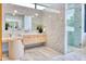 Bright bathroom featuring marble countertops, modern mirrors, and a glass-enclosed shower at 6215 N Casa Blanca Dr, Paradise Valley, AZ 85253