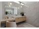 Modern bathroom featuring marble walls, a floating vanity, and a large mirror at 6215 N Casa Blanca Dr, Paradise Valley, AZ 85253