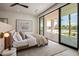 Bright bedroom with a plush bed, artwork, and a sliding glass door leading to the patio at 6215 N Casa Blanca Dr, Paradise Valley, AZ 85253