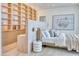Bright bedroom featuring built-in shelving, modern art, and a cozy bed with decorative pillows at 6215 N Casa Blanca Dr, Paradise Valley, AZ 85253