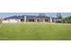 Expansive green lawn and modern home with a dark metal roof at 6215 N Casa Blanca Dr, Paradise Valley, AZ 85253