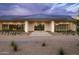Striking exterior view of a modern home with clean lines, stone accents, and a landscaped yard at 6215 N Casa Blanca Dr, Paradise Valley, AZ 85253