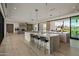 Expansive kitchen with modern fixtures and dual islands flows into the living room creating an inviting space at 6215 N Casa Blanca Dr, Paradise Valley, AZ 85253