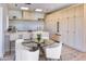 Bright kitchen featuring sleek wood cabinets, a skylight, quartz countertops, and a glass-top dining table at 6215 N Casa Blanca Dr, Paradise Valley, AZ 85253