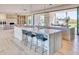 Open-concept kitchen with large island, bar seating, and a view to outdoor living area at 6215 N Casa Blanca Dr, Paradise Valley, AZ 85253