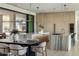 Well-lit kitchen boasts a marble island, modern cabinetry, and seamless flow into the dining area at 6215 N Casa Blanca Dr, Paradise Valley, AZ 85253