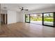Bright living room with hardwood floors and expansive sliding doors, offering stunning views at 6215 N Casa Blanca Dr, Paradise Valley, AZ 85253