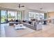 Spacious living room with a large sectional sofa and seamless flow to the kitchen and outdoor areas at 6215 N Casa Blanca Dr, Paradise Valley, AZ 85253