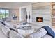Bright living room with a modern fireplace, sleek decor, and open access to other living areas at 6215 N Casa Blanca Dr, Paradise Valley, AZ 85253