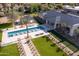 A backyard view of a luxurious pool area, featuring palm trees, lounge chairs and green grass at 6215 N Casa Blanca Dr, Paradise Valley, AZ 85253