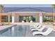 Relaxing pool area with lounge chairs, palm trees, and a modern home design at 6215 N Casa Blanca Dr, Paradise Valley, AZ 85253