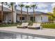 Stunning backyard featuring a sparkling pool, lush landscaping, and comfortable lounge chairs at 6215 N Casa Blanca Dr, Paradise Valley, AZ 85253
