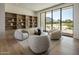 Bright sitting room features large windows with mountain views, plush seating, and custom built-in shelves at 6215 N Casa Blanca Dr, Paradise Valley, AZ 85253