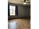 A bedroom featuring hardwood flooring, neutral walls, and a mirrored closet at 815 W Kiva Ave, Mesa, AZ 85210
