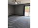 Comfortable bedroom with new carpet, a sliding glass door to backyard, and a ceiling fan at 815 W Kiva Ave, Mesa, AZ 85210