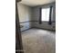 A bedroom features neutral carpet, and neutral walls with black trim at 815 W Kiva Ave, Mesa, AZ 85210