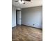 Bedroom features wood-look flooring, neutral paint, and an open doorway at 815 W Kiva Ave, Mesa, AZ 85210