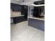 A kitchen featuring tile flooring, granite countertops, black cabinets, and stainless steel appliances at 815 W Kiva Ave, Mesa, AZ 85210