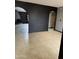 A spacious living room featuring neutral tile flooring and an arched entryway to a fireplace area at 815 W Kiva Ave, Mesa, AZ 85210